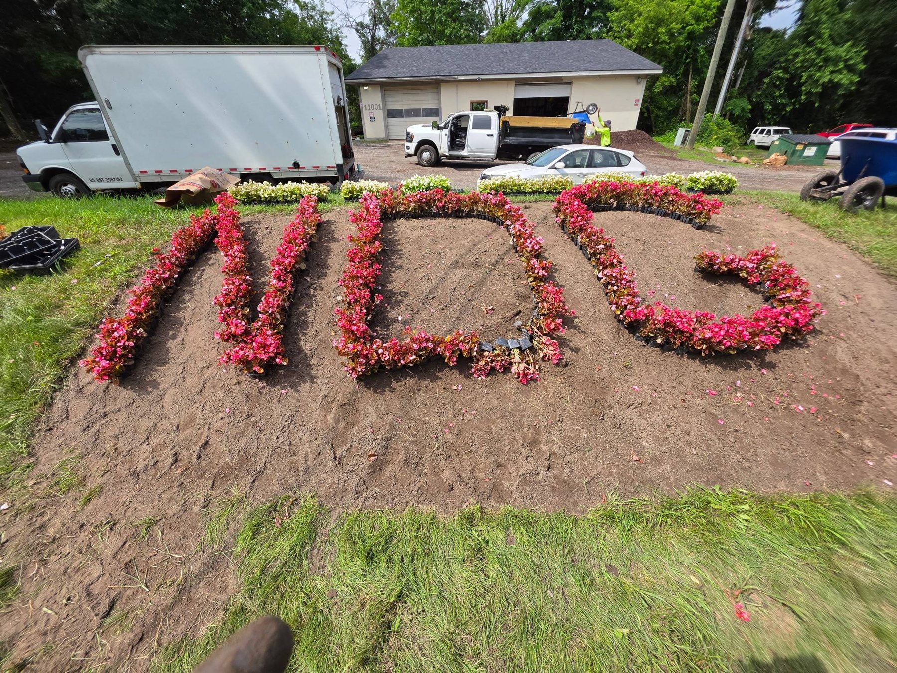NDG spelled out in a red flower bed